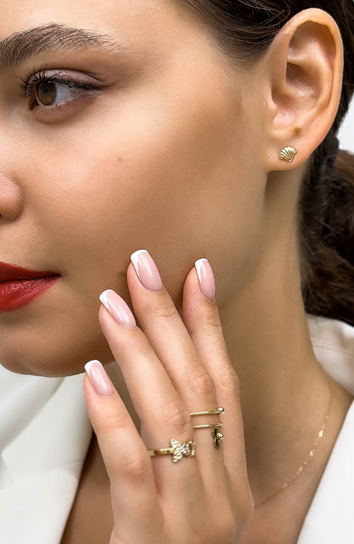 MS Gems by Mamta's commitment to craftsmanship, shown through a jeweler's hands meticulously setting a brilliant-cut diamond in gold.