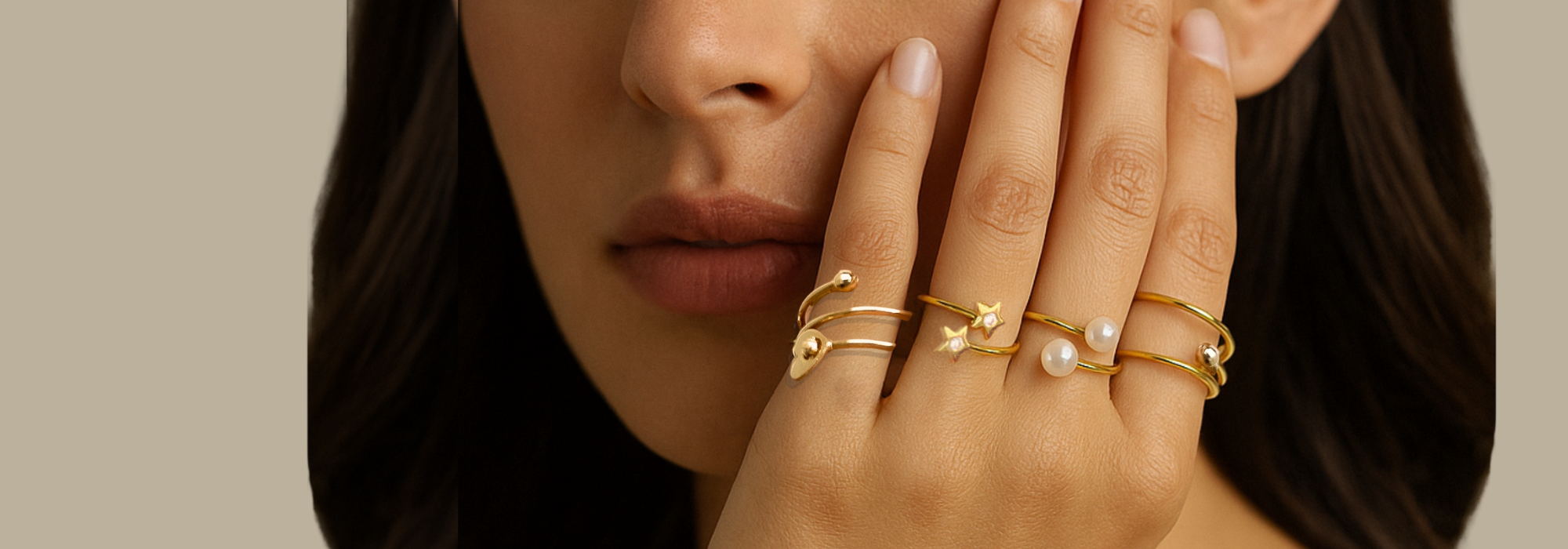 A perfectly styled photograph showcasing a stack of multiple gold and sparkle rings on women hand  from MS Gems by Mamta's collection.